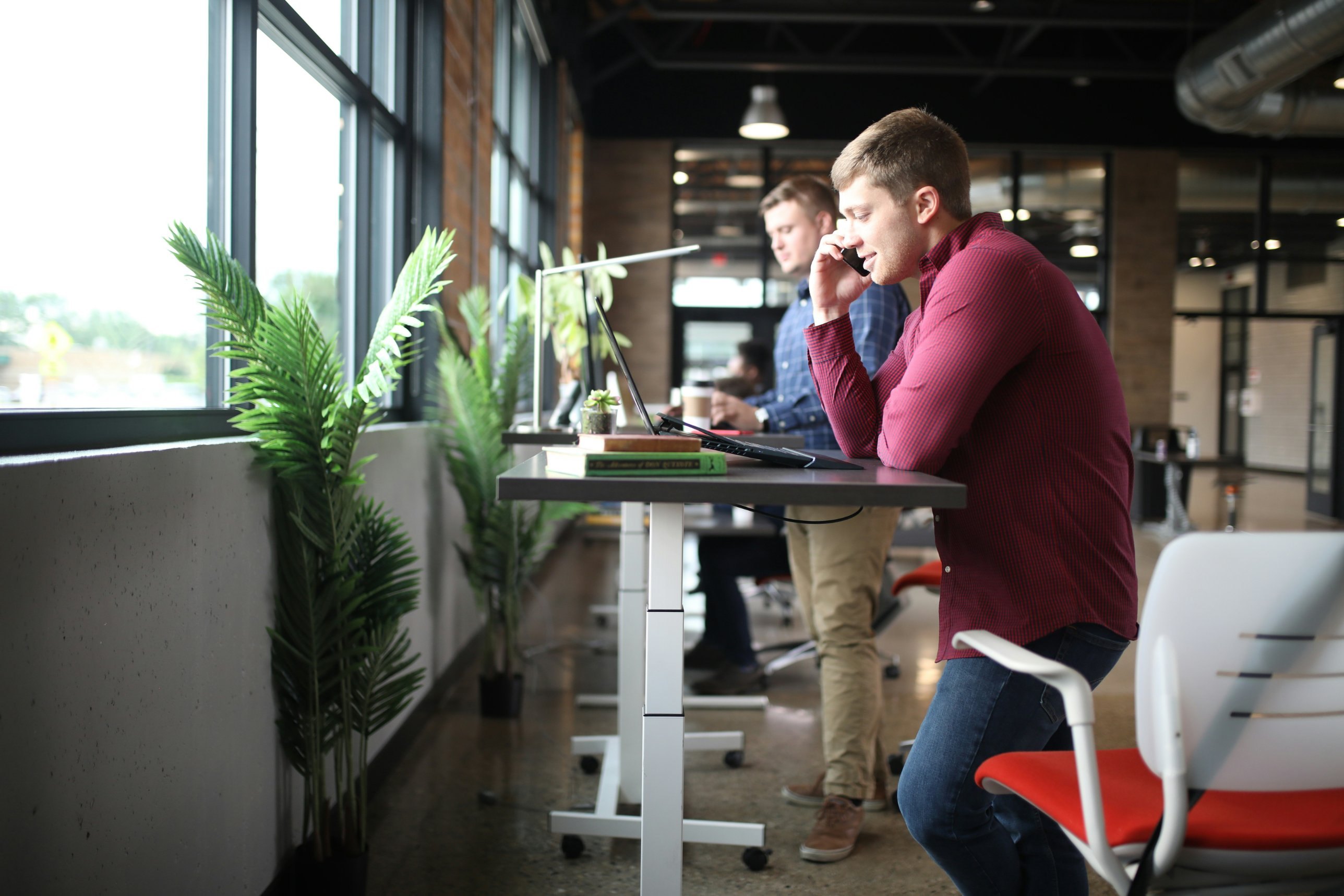 Colleagues working at standing desks in a bright office